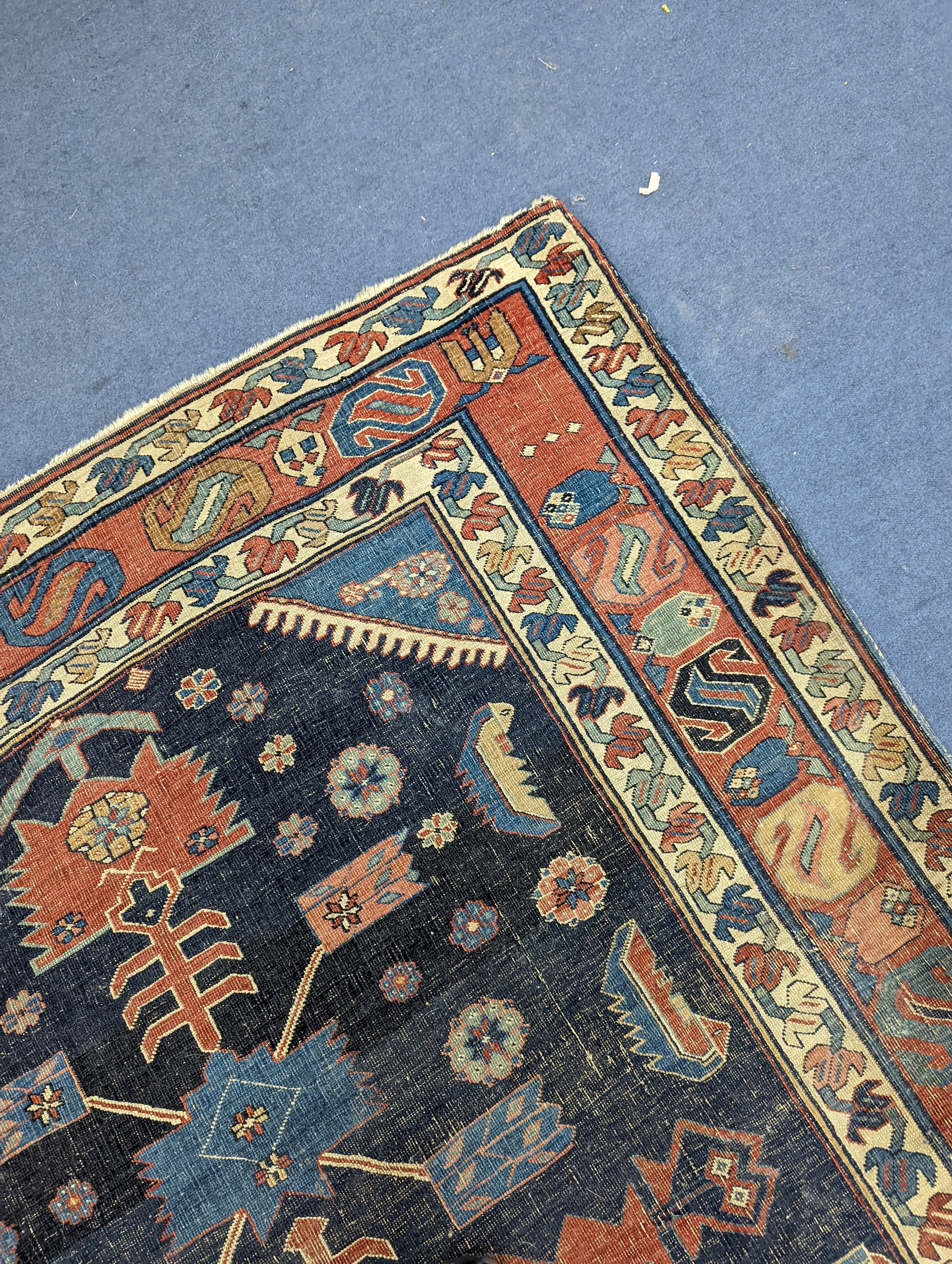 An antique Caucasian blue ground rug (worn), 200 x 148cm